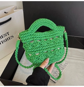 Detail of green woven handbag featuring high-quality cotton rope texture and golden hardware