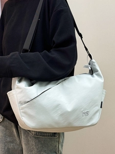 Minimalist mint green crossbody dumpling bag with MS embroidery and adjustable strap
