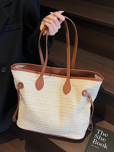 Contrast straw tote bag with brown leather handles and spacious interior for daily use