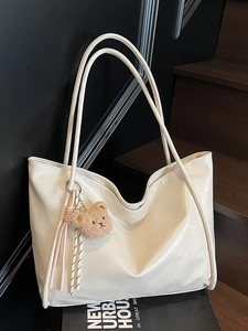 Cream white faux leather tote bag with long straps and brown plush bear charm