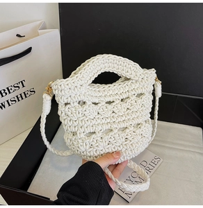 Detail of cream woven handbag with thick rope texture and gold metal hardware