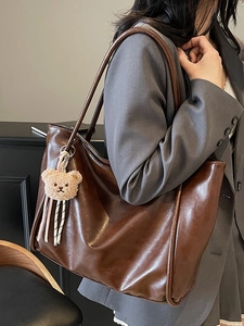 Retro brown large leather tote bag for women with a cute plush bear charm accessory