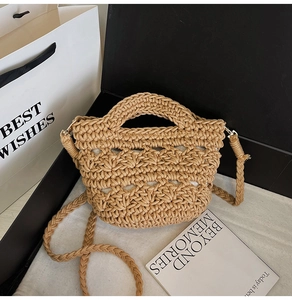 Detail of the hollow-out woven texture and circular handle on this beige straw handbag