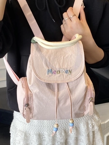 Minimalist light pink nylon backpack with MeaRey embroidery and beaded drawstring details