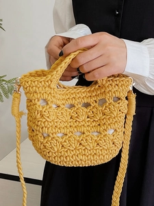 Handmade yellow woven crochet mini tote bag with hollow pattern and shoulder strap