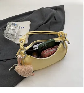 Interior view of yellow crescent shoulder bag showing spacious storage for daily essentials