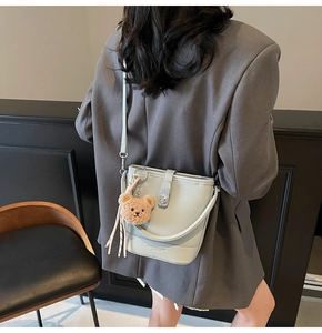 Macro view of light blue lychee pattern leather bucket bag with silver metal twist lock