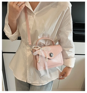 Petit sac carré rose en cuir avec détails en dentelle blanche et nœud de perles