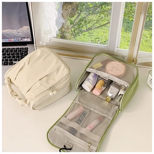 Detail of travel makeup bag set with mesh pockets and elegant pearl zipper puller