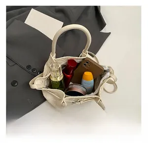 Interior view of off-white woven bucket bag showing large capacity for essentials