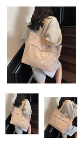 Detailed view of the large canvas shoulder bag featuring stylish BUDBAO embroidery