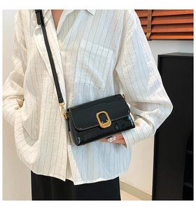 Vue détaillée du sac à bandoulière en cuir verni noir avec boucle en métal doré chic