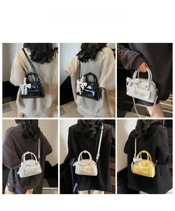 Multi-color mini Boston bags with bow detail and ribbon handles shown on models