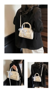Detailed views of a cream Boston bag with a blue plaid ribbon on the handle