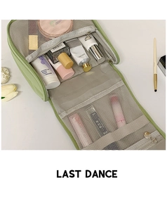 Detail view of mint green travel cosmetic bag with folding mesh organizer pockets