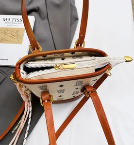 Close-up of printed bucket bag with gold zipper detail and spacious interior opening