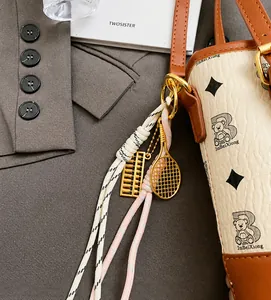 Detail showing the cream bucket bag with golden abacus charm and bear print patterns