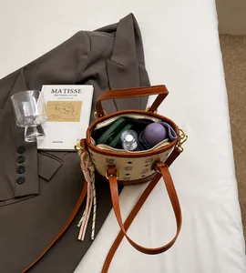 Spacious interior of monogram bucket bag showing storage for umbrella and makeup