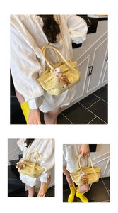 Detail view of yellow woven tote bag featuring a cute teddy bear charm and crossbody strap