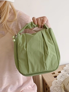 Minimalist grass green pleated makeup bag with pearl charm and smooth zipper for travel