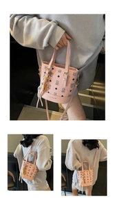 Pink bucket bag with classic print and adjustable strap shown on a model from different angles