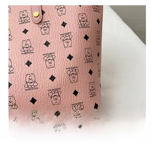 Close-up of pink leather tote bag with classic bear prints and diamond patterns
