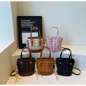Detailed view of bucket bags in five colors with vintage bear monogram and tassel accents