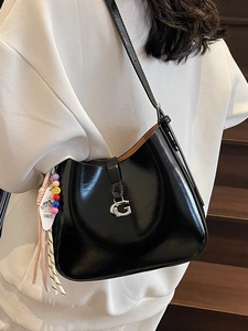 Minimalist black patent leather underarm bag with silver G buckle and beaded charm