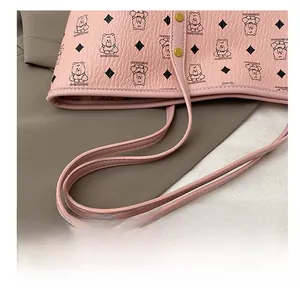 Detail shot of the pink tote bag strap with fine stitching and golden metal rivets