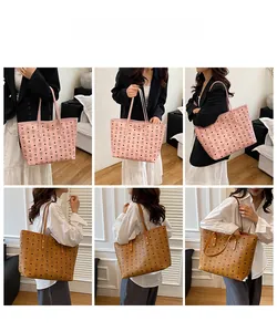 Detail view of large tote bags in pink and brown with bear pattern and long shoulder straps