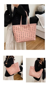 Detail of light pink tote bag featuring black bear pattern and durable shoulder straps
