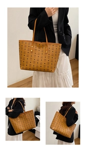 Detail of classic cognac tote bag with bear print pattern and golden rivets reinforcement