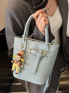 Light blue lychee texture bucket bag with handle and cute doll charm for women
