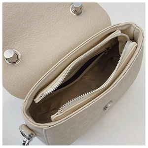 Detailed interior of beige crossbody bag with monogram pattern and multi-pocket design