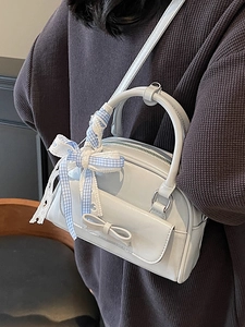 Light blue patent leather Boston bag with ribbon bow and stylish crossbody strap