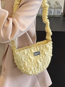 Bright yellow pleated cloud bag with scrunchie strap and textured fabric moon shape