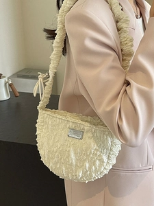 Chic beige ruched cloud shoulder bag with textured fabric and metallic brand plate