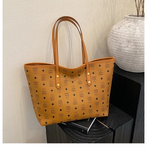 Detailed close-up of large tote bag featuring classic brown pattern on a wooden display