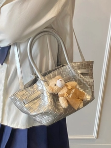 Silver woven crossbody bag with a cute bear charm for women fashion style