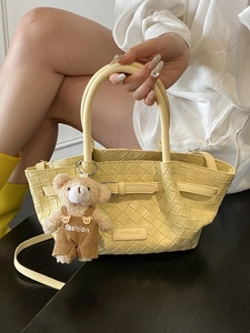 Elegant pale yellow woven leather tote bag with a small bear charm for women
