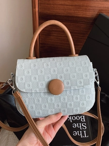 Light blue plaid mini square handbag with brown leather handles and adjustable shoulder strap