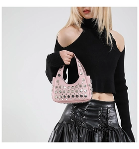 Dettaglio borsa a secchiello in pelle rosa con borchie metalliche argentate stile punk