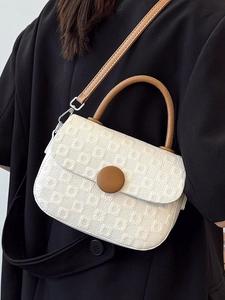Minimalist cream textured square handbag with brown leather handles and shoulder strap