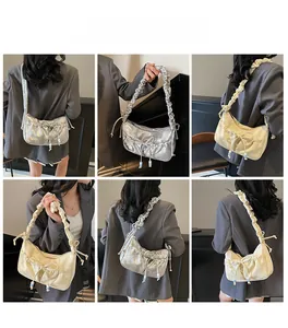 Detailed views of French-style ruffled shoulder bag with bow and beaded pendant