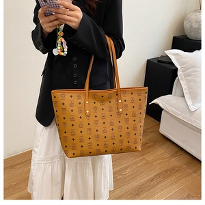 Detail showing high-capacity brown tote bag with cartoon bear print and leather straps