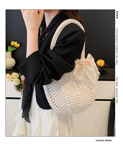 Detail of hand-woven cream tote bag featuring intricate floral lace and embroidery