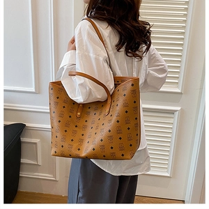 Classic patterned large tote bag with brown leather texture shown on model for daily commute