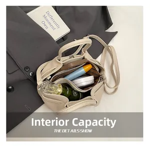 Internal view of beige wrinkled tote bag showing makeup storage and zipper compartment