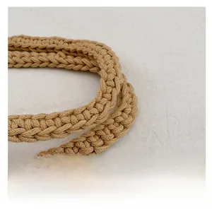 Close-up detail of khaki cotton woven tote bag handle with thick textured braided straps