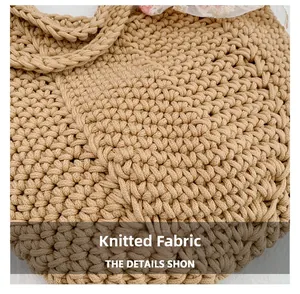 Close-up of the handcrafted knitted texture and floral lace detail on the beige tote bag